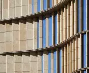 The 35 Hudson Yards skyscraper in New York City - the skyscraper's facades combine glass with vertical pleats of limestone.
