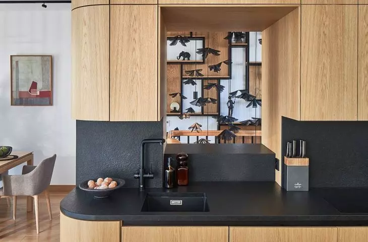 The kitchen is distinguished by built-ins with a clearance over the hob, which optically opens up the space and gives it lightness