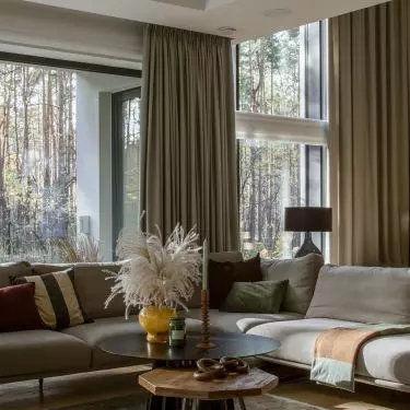 High living areas with walls of glass open up interiors to garden and surroundings