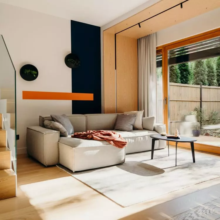 The wall behind the sofa has been colorfully divided into three contrasting stripes