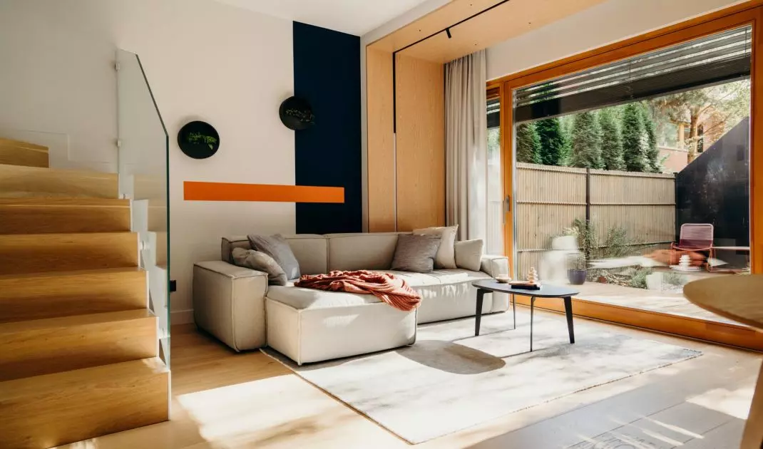 The wall behind the sofa has been colorfully divided into three contrasting stripes