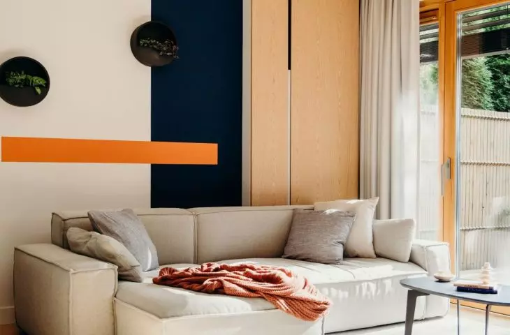 The focal point of the living area is a comfortable gray sofa