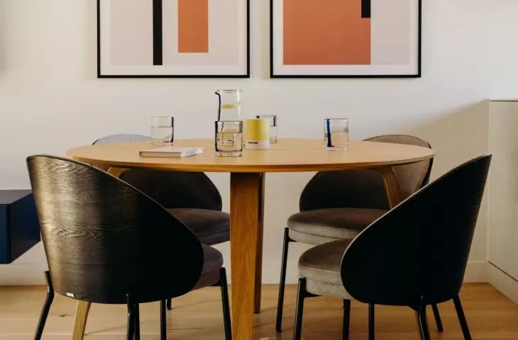 Above the table in the dining area hangs a designer lamp resembling a cloud