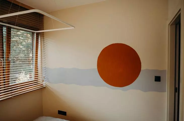 The wall opposite the bed is decorated with a mural