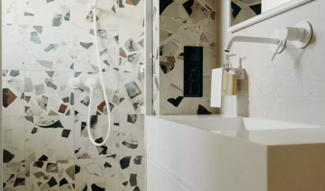 The small bathroom managed to accommodate a shower