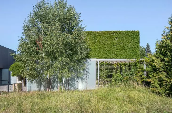 Part of the upper floor is covered by a green facade