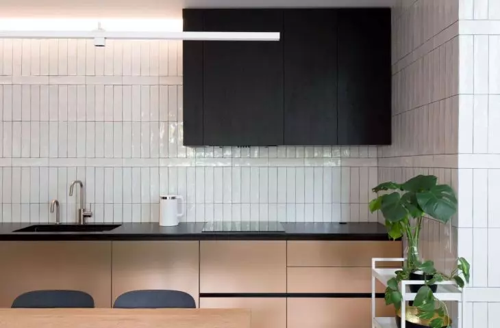 Matte furniture fronts create an intriguing contrast to glazed tiles