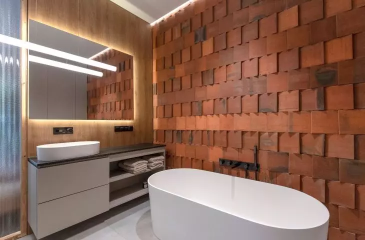 Rustic terracotta tiles were juxtaposed with a brick wall and a modern bathtub 