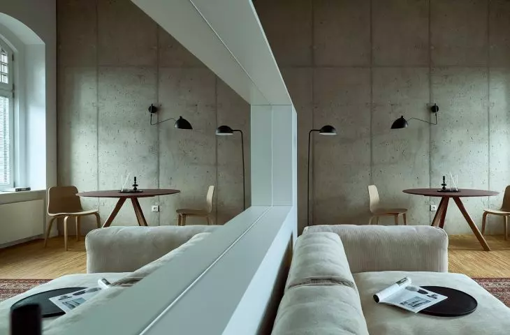 The kitchenette, though not large, has been separated from the living room by a partition with a built-in mirror