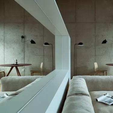 The kitchenette, though not large, has been separated from the living room by a partition with a built-in mirror