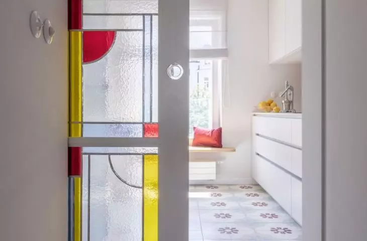 Stained glass artists made a glazed interior door referring to Art Nouveau details