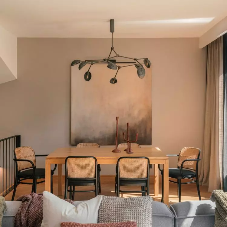 A painting by Agnieszka Kirzanowska-Osinska adorns the wall of the dining room