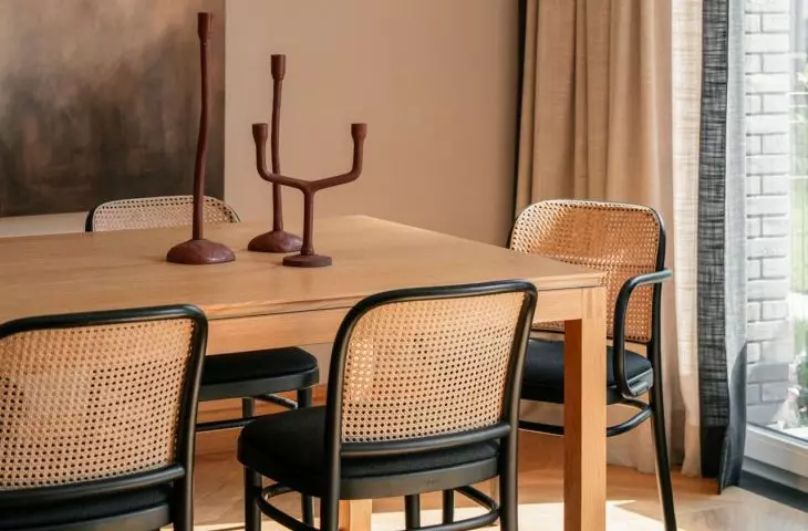 Above the table hung a lamp with a sculptural form