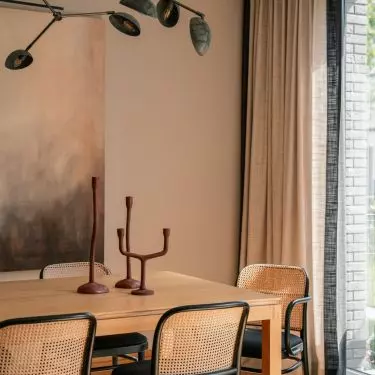 Above the table hung a lamp with a sculptural form