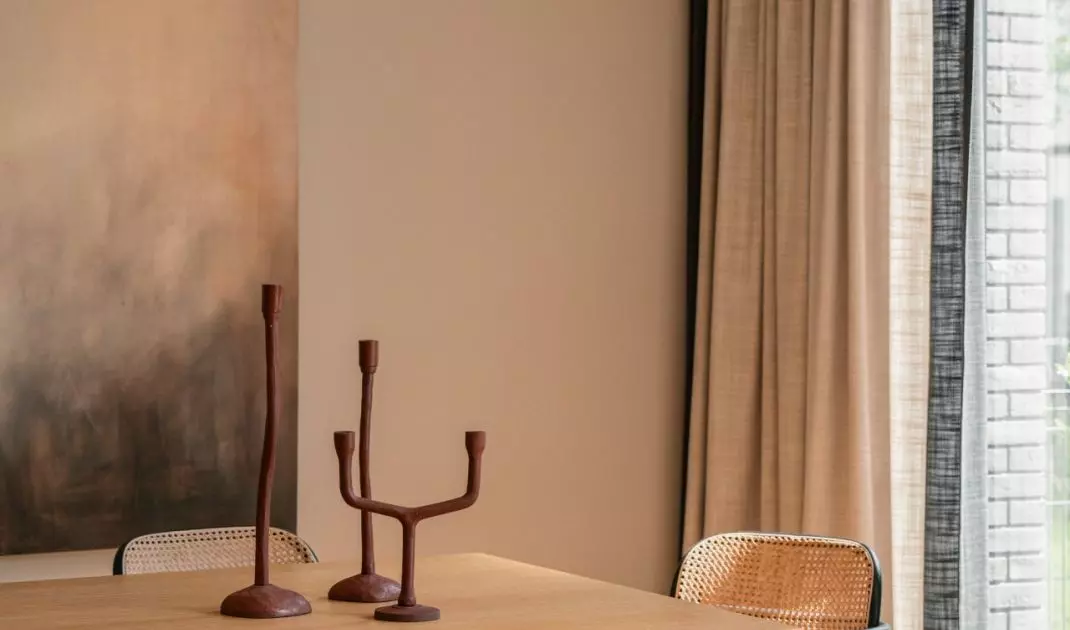 Above the table hung a lamp with a sculptural form