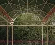 The colors of the structure - mint green roofs, cream-colored beams and bright red balustrades - create a cohesive aesthetic