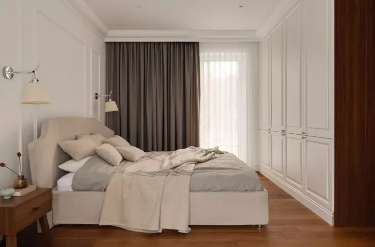 A furniture cabinet on either side of the bedroom entrance cleverly hides the TV and appliances
