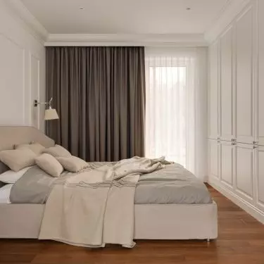 A furniture cabinet on either side of the bedroom entrance cleverly hides the TV and appliances