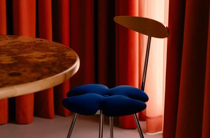 The table is surrounded by chairs, each of which tells its own story