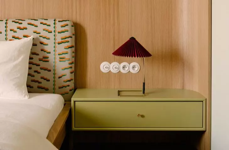 Behind the bed, up to half the height of the wall, light wood was used