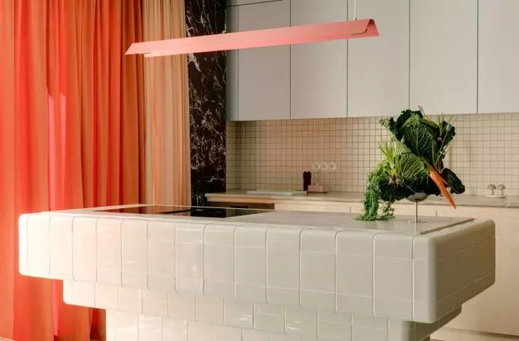 The kitchen island was finished with bright, glossy tiles