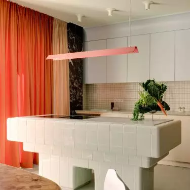 The kitchen island was finished with bright, glossy tiles