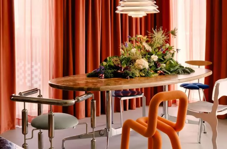The centerpiece of the dining room is a handcrafted solid wood table from Polish brand Szyszka Design