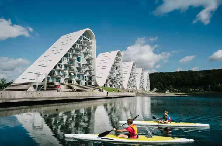 The Wave apartment complex in Vejle, Denmark - the reflections of the blocks in the calm surface of the fjord enhance the visual harmony of the complex
