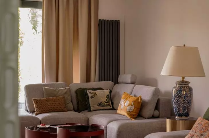 The living room impresses with a gray sofa with soft velour upholstery
