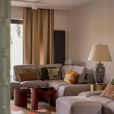 The living room impresses with a gray sofa with soft velour upholstery