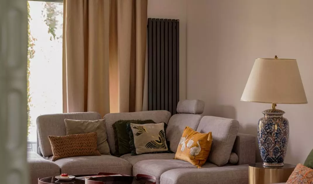 The living room impresses with a gray sofa with soft velour upholstery