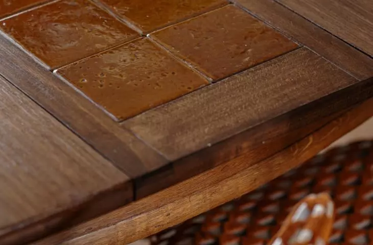 The table incorporates a ceramic insert made of floor tiles