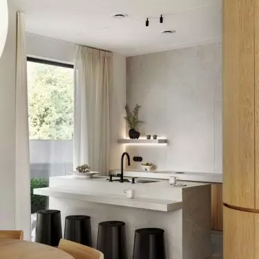 Rounded hockers contrast with the sharp lines of the kitchen island