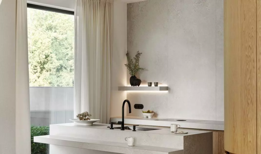 Rounded hockers contrast with the sharp lines of the kitchen island