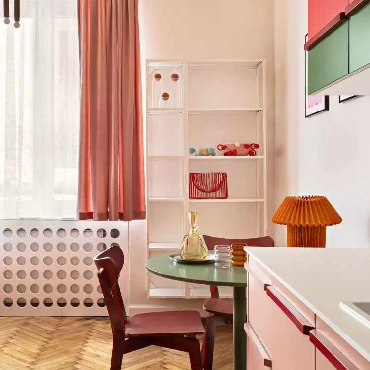 The green table is complemented by red chairs
