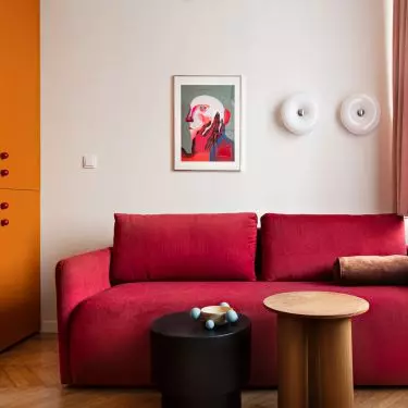 Red sofa bed coordinates perfectly with orange closet