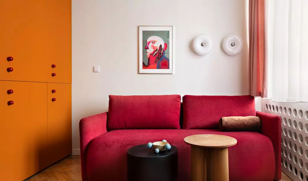 Red sofa bed coordinates perfectly with orange closet