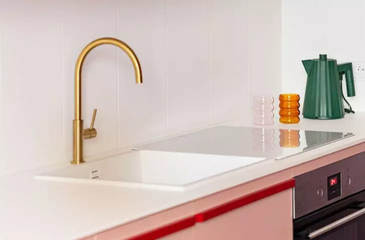 The upper cabinets surprise with a bold palette: from yellow, to green, to dark raspberry