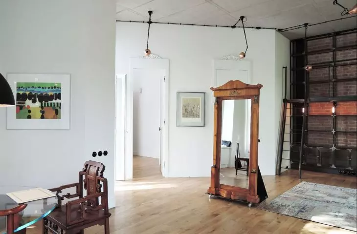 Loft style interior with a classic mirror on a stand 