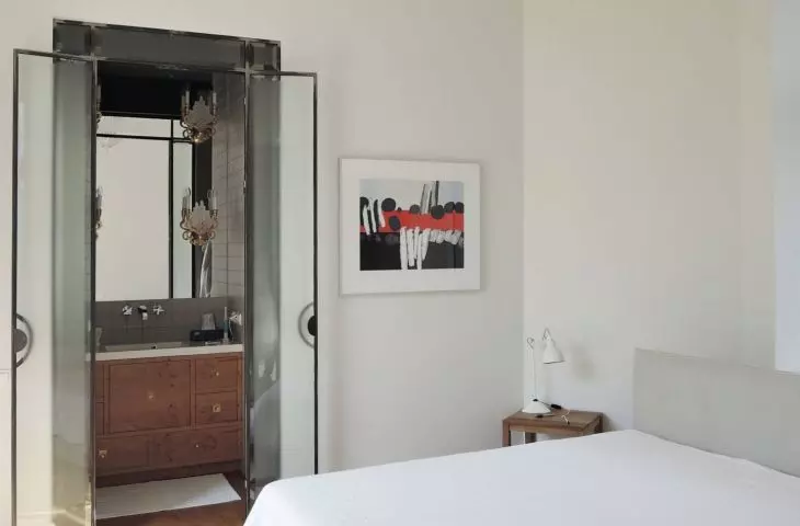 A bedroom with an en-suite bathroom, accessed by a loft door