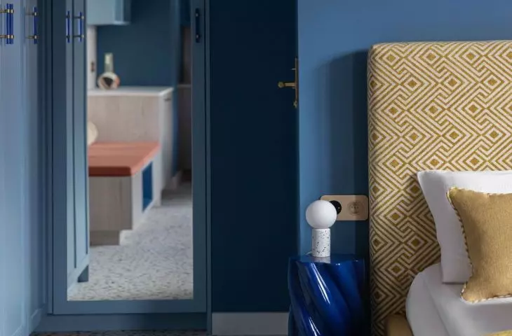 Behind the bedroom area is a small bathroom