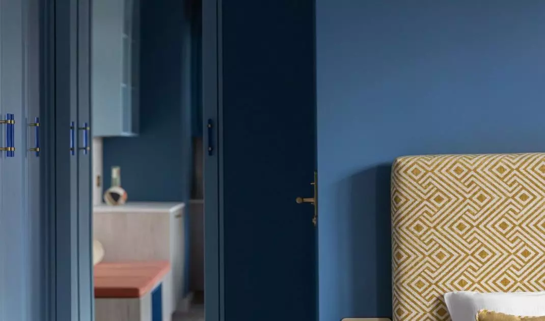 Behind the bedroom area is a small bathroom