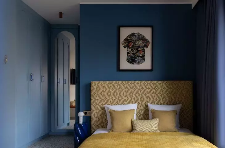 A framed Hawaiian shirt hung over the bed