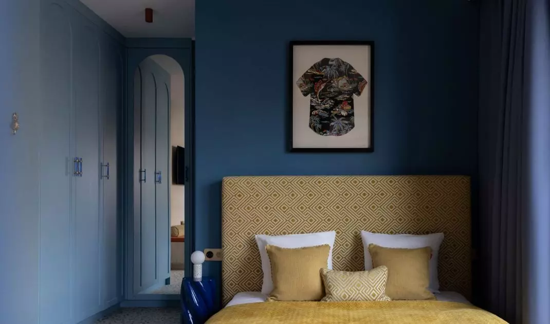 A framed Hawaiian shirt hung over the bed