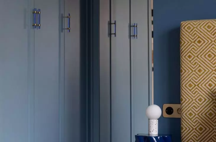 Closet blends in with navy blue wall