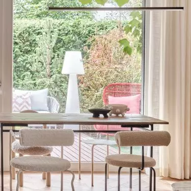 The dining room overlooks the greenery outside the window 