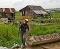 resident by his wooden boat