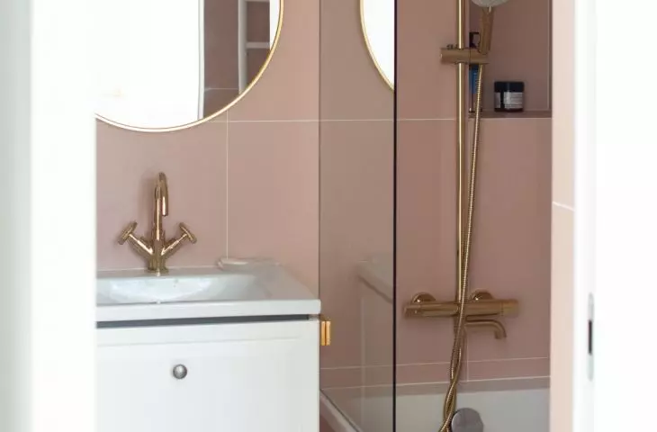 Pink tiles on the bathroom walls add softness and feminine charm to the interior