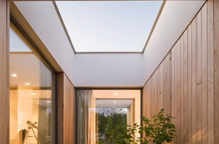 Inner courtyard as part of L-shaped house layout, providing light and intimacy for residents