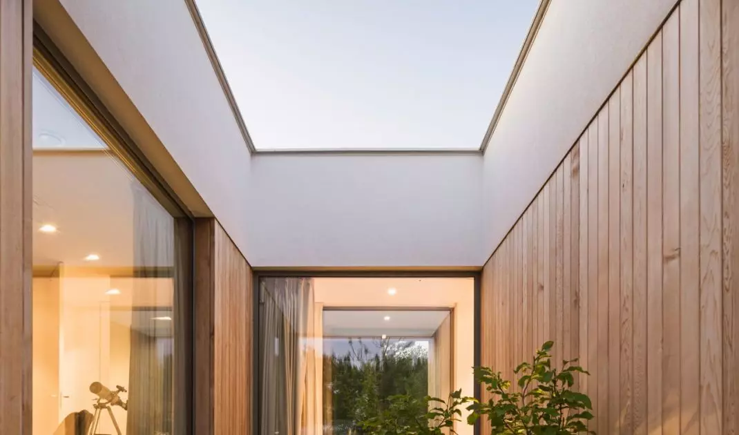 Inner courtyard as part of L-shaped house layout, providing light and intimacy for residents